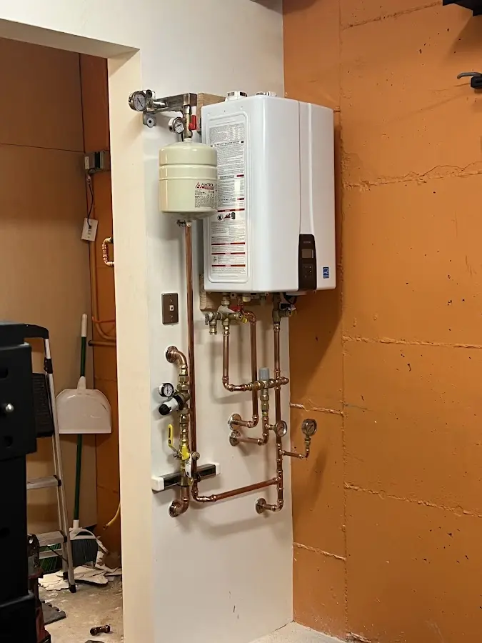 Plumbing technician inspecting water heater connections in Cayce